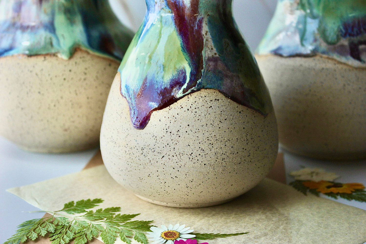 Set of three handmade rainbow vases with vibrant color drips, each uniquely glazed with a bold and colorful design, perfect for home decor or as a special gift.
