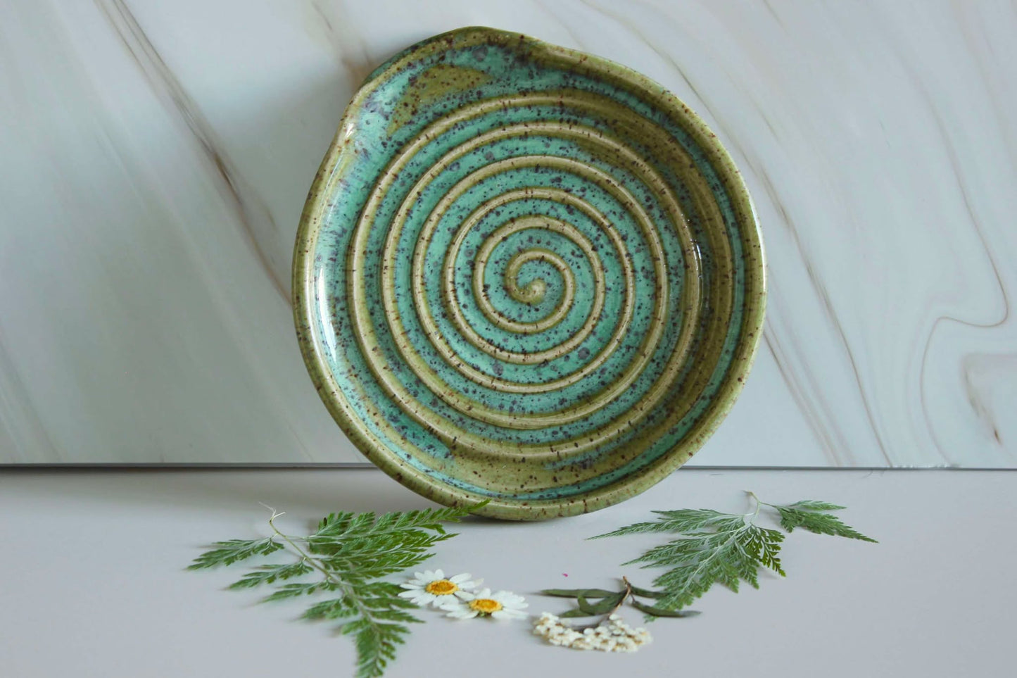 "Handmade Fern Spoon Rest, a ceramic kitchen accessory with earthy green tones, perfect for holding utensils while cooking.