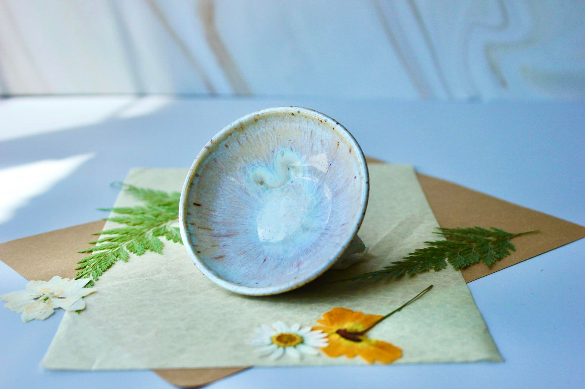 Handmade pearl ring dish jewelry holder with a cool iridescent white finish, inspired by the beauty of pearls.